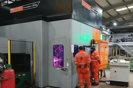 The newly installed PeddiBot-1250 robotic structural steel fabrication machine 